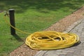 Large coiled yellow hose pipe Royalty Free Stock Photo