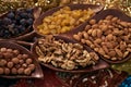 Large collection of nuts, seeds and dried fruits in brown wooden bowls Royalty Free Stock Photo