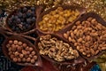 Large collection of nuts, seeds and dried fruits in brown wooden bowls Royalty Free Stock Photo