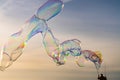 Large colorful bubbles on the beach with sunlight refracting through.