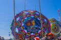 large colorful kite with figures of women in circles with people in front