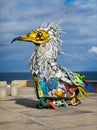 Large and colourful metal bird of prey made from pieces of junk near the sea in Los Silos, Tenerife, Spain