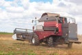 A large combine works in a wheat field