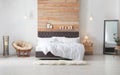 Large comfortable bed in stylish room. Modern interior Royalty Free Stock Photo