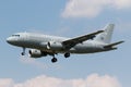 a large commercial airplane with its landing gear down flying through the air