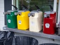 Large commercial dispensers of Heinz ketchup, mustard, relish, and mayonnaise outside for hot dogs and hamburgers