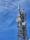A large communication tower (communication tower) with numerous antennas and satellite dishes. Royalty Free Stock Photo