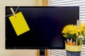 Large computer monitor with yellow reminder note clipped to left Royalty Free Stock Photo
