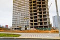 Large concrete cement modern under construction new modern monolithic frame-block house building with windows, walls and balconies Royalty Free Stock Photo