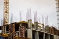 Large concrete cement modern under construction new modern monolithic frame-block house building with windows, walls and balconies Royalty Free Stock Photo