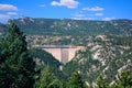 Large Concrete Dam and Reservoir in the Mountains on a Sunny Day