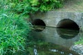 A large concrete pipe for diverting the river under the highway. Leaky dirty water from large concrete pipes. Dirty sewage from