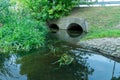 A large concrete pipe for diverting the river under the highway. Leaky dirty water from large concrete pipes. Dirty sewage from