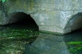 A large concrete pipe for diverting the river under the highway. Leaky dirty water from large concrete pipes. Dirty sewage from