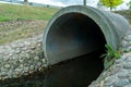 A large concrete pipe for diverting the river under the highway. Leaky dirty water from large concrete pipes. Dirty sewage from