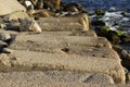 Large concrete rectangular blocks to protect the shore from erosion lie in the sea. Enclosure of railroad tracks Royalty Free Stock Photo