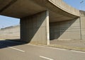 Large concrete road underpass with a four lane street under it. Royalty Free Stock Photo