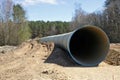 Large  concrete sewer pipe lie on  construction site in the spring forest Royalty Free Stock Photo