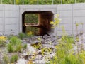 Large concrete stream culvert illuminated by sunset Royalty Free Stock Photo