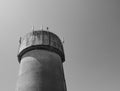 Large, concrete water tower with telecom and wireless 4G antennas. Royalty Free Stock Photo