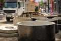 Large concrete wells for city sewerage. Public utilities workers are replacing the water supply system in the city