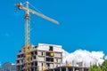 A large construction crane against the blue sky.