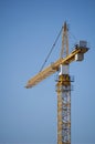 Large construction site cranes working on a building complex with clear blue sky
