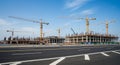 Large Construction Site with Multiple Cranes and Unfinished Buildings Under Blue Sky industry Royalty Free Stock Photo