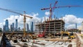 Large Construction Site with Multiple Cranes and Workers in Urban Area Royalty Free Stock Photo