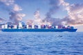 Large container cargo ship in the ocean, side view.