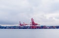 Large container cranes and cargo ship in Vancouver Harbour, BC, Canada