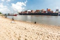 Large container vessel and city beach
