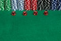 Large copy writing space with betting chips and 4 translucent red casino style dice on a green felt playing surface. Vivid colors