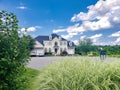 Large country home with large parking lot in the front yard. Blue skies on a summer day Royalty Free Stock Photo