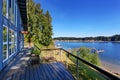 Large covered porch of luxury home with lake view. Royalty Free Stock Photo