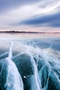 Large cracks in the clear smooth blue ice of Lake Baikal at sunset. Siberia Russia Royalty Free Stock Photo