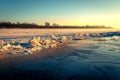 Large cracks on surface of the ice on the sunrise. Ice hummocks on the river. Royalty Free Stock Photo