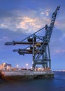 Large crane at container terminal at twilight in Port of Antwerp, Flanders, Belgium Royalty Free Stock Photo