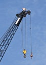 A large crane fills a blue sky