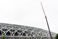 Large crane on the  metal framework of stadium roof, the construction of new sport arena, isolated on white background Royalty Free Stock Photo