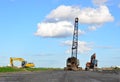 Large crawler crane or dragline excavator with a heavy metal wrecking ball on a steel cable.