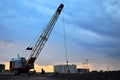 Large crawler crane or dragline excavator with a heavy metal wrecking ball on a steel cable.