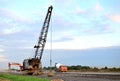 Large crawler crane or dragline excavator with a heavy metal wrecking ball on a steel cable. Wrecking balls at construction sites