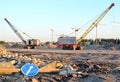 Large crawler crane or dragline excavator with a heavy metal wrecking ball on a steel cable.