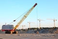 Large crawler crane or dragline excavator with a heavy metal wrecking ball on a steel cable.