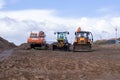 large crawler excavators standing at a construction site