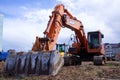 large crawler excavators standing at a construction site