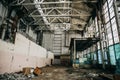 Large creepy abandoned industrial warehouse or factory building inside with broken ruined wall from glass blocks Royalty Free Stock Photo