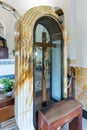 A large cross with a crucifix in the central hall of the Beatitude Monastery located on the mountain on the coast of the Sea of Ga