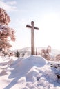 Large cross on a hill covered in snow